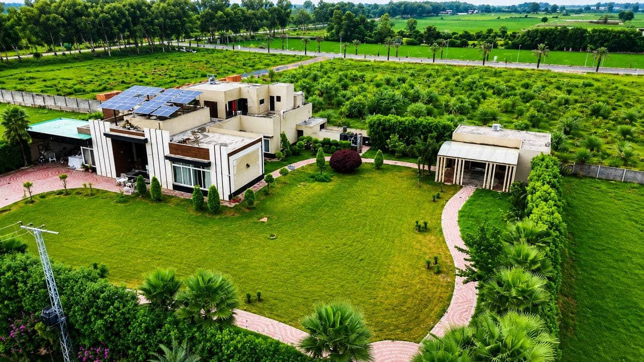 A landscaped farmhouse residence with mature planting at Palm Valley Farms